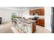 Open kitchen features a center island with barstool seating and stainless steel appliances at 2024 Griffin Oaks Way, Tavares, FL 32778