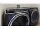 This is a modern laundry room with GE washer and dryer at 2024 Griffin Oaks Way, Tavares, FL 32778