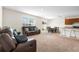 Spacious open-plan living room with cozy seating, dining area and kitchen at 2024 Griffin Oaks Way, Tavares, FL 32778