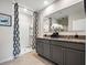 Modern bathroom featuring a granite countertop, dual sinks, and a walk-in shower with modern finishes at 2219 Lake Preserve Cir, New Smyrna Beach, FL 32168
