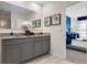 An elegant bathroom featuring granite countertops, dual vanities, and an open view to the main bedroom at 2219 Lake Preserve Cir, New Smyrna Beach, FL 32168
