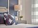 Stylishly decorated bedroom details a plush bed, decorative lamps, and luxurious accent pillows at 2219 Lake Preserve Cir, New Smyrna Beach, FL 32168