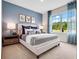 This bright bedroom features soft carpeting, bright natural light, and a well-appointed, calming space at 2219 Lake Preserve Cir, New Smyrna Beach, FL 32168