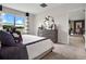 Inviting bedroom featuring plush carpeting, ample natural light, and neutral walls with navy accents at 2219 Lake Preserve Cir, New Smyrna Beach, FL 32168