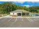 Aerial view of the community pool with parking, green spaces, and lounge chairs at 2219 Lake Preserve Cir, New Smyrna Beach, FL 32168