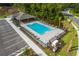 Aerial view of a community pool showcasing the pool layout with lounge chairs and green spaces at 2219 Lake Preserve Cir, New Smyrna Beach, FL 32168