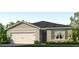 Charming one-story home featuring a two-car garage, neutral stucco exterior, and manicured lawn at 2219 Lake Preserve Cir, New Smyrna Beach, FL 32168