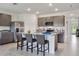 Bright kitchen features gray cabinetry, stainless steel appliances, and a large island with bar seating at 2219 Lake Preserve Cir, New Smyrna Beach, FL 32168