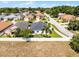 Aerial view of a well-maintained home with fenced backyard, palm tree, and surrounding neighborhood at 239 Bronze Leaf Ct, Apopka, FL 32703