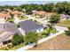 Overhead view of home with fenced yard, mature trees, and a view of the surrounding neighborhood at 239 Bronze Leaf Ct, Apopka, FL 32703