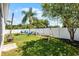 Spacious backyard featuring a swing set, lawn, seating, and a white fence at 239 Bronze Leaf Ct, Apopka, FL 32703