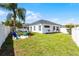 A spacious backyard features a well maintained lawn with plenty of room for outdoor activities at 239 Bronze Leaf Ct, Apopka, FL 32703