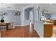Open concept dining room with wood floors, archways and connected kitchen at 239 Bronze Leaf Ct, Apopka, FL 32703