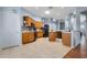 Spacious kitchen featuring wooden cabinets, stainless appliances and tile floors at 239 Bronze Leaf Ct, Apopka, FL 32703