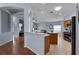 Bright and airy kitchen flowing into the living area with open archways and tiled floors at 239 Bronze Leaf Ct, Apopka, FL 32703