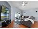 Living room with sectional sofa, two televisions and access to the outdoor space at 239 Bronze Leaf Ct, Apopka, FL 32703