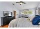 Cozy bedroom with a soft bed, ceiling fan, and large windows creates a peaceful retreat at 239 Bronze Leaf Ct, Apopka, FL 32703