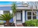 Inviting front porch with a white door, lush landscaping, and modern exterior lighting for curb appeal at 2413 Weber St, Orlando, FL 32803