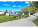 Charming blue single story home with a well-manicured lawn and a brick-paved walkway to the front door at 2413 Weber St, Orlando, FL 32803