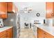 Bright kitchen featuring stainless steel appliances, tile floors, and wood cabinets at 2413 Weber St, Orlando, FL 32803