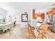 Bright kitchen featuring breakfast bar, stainless appliances, granite countertops, and open layout to dining and office spaces at 2413 Weber St, Orlando, FL 32803