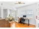 Home office featuring hardwood floors, built-in shelving and adjacent dining area at 2413 Weber St, Orlando, FL 32803