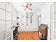Bright office featuring hardwood floors, built-in shelving, ceiling fan, and ample natural light at 2413 Weber St, Orlando, FL 32803