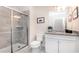 Modern bathroom with a glass-enclosed shower and a white vanity with granite countertop at 2486 Dubai St, Kissimmee, FL 34747