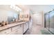 Spacious bathroom with dual vanity, granite countertop, and a glass-enclosed shower at 2486 Dubai St, Kissimmee, FL 34747