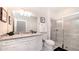 Clean bathroom featuring a glass shower, white vanity with granite countertops, and modern fixtures at 2486 Dubai St, Kissimmee, FL 34747
