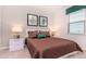Cozy bedroom with a quilted bedspread, neutral tones, and decorative artwork at 2486 Dubai St, Kissimmee, FL 34747