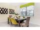 This dining room features a modern table with seating for six and stylish decor accents at 2486 Dubai St, Kissimmee, FL 34747