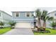 Charming two-story blue home with well-manicured landscaping and a two-car garage at 2486 Dubai St, Kissimmee, FL 34747