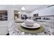 Detail of kitchen island with granite countertop and barstool seating with modern tableware at 2486 Dubai St, Kissimmee, FL 34747