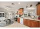 Spacious kitchen with tile flooring, wood cabinets and breakfast nook overlooking living areas at 27019 Old English Ct, Leesburg, FL 34748