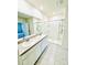 Bathroom with dual sinks, large mirror, tiled floor, and a walk-in shower at 2837 Palatino Lane, Tavares, FL 32778