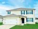 Charming two-story home featuring a well-manicured lawn and inviting front entrance at 2837 Palatino Lane, Tavares, FL 32778