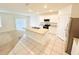 Open kitchen featuring an island with a sink and views of the carpeted living area at 2837 Palatino Lane, Tavares, FL 32778