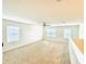 Spacious living room with carpet, ceiling fan, and bright windows at 2837 Palatino Lane, Tavares, FL 32778
