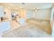 Spacious open-concept living area with a bright kitchen island, plush carpeting, and lots of natural light at 2837 Palatino Lane, Tavares, FL 32778