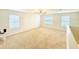 Large loft area with carpet, ceiling fan, and windows at 2837 Palatino Lane, Tavares, FL 32778