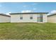 The home has a cozy backyard with a well-maintained lawn and a small brick patio at 3069 Cassidy Ln, Haines City, FL 33844