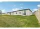 Exterior image of a spacious backyard with lush green grass and a white fence at 3069 Cassidy Ln, Haines City, FL 33844