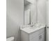 This bathroom features a white single sink vanity with tiled countertop and a large mirror at 3069 Cassidy Ln, Haines City, FL 33844