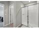 Bright bathroom featuring a glass shower with a chrome frame and a view to the bedroom entrance at 3069 Cassidy Ln, Haines City, FL 33844