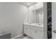 Bright bathroom featuring a double vanity with white cabinets, modern faucets, and tile flooring at 3069 Cassidy Ln, Haines City, FL 33844