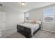 Bright bedroom with neutral walls, carpet floors, a black sleigh bed, and filled with natural light at 3069 Cassidy Ln, Haines City, FL 33844