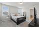 A cozy bedroom featuring neutral walls, a black sleigh bed, two windows, and carpet flooring at 3069 Cassidy Ln, Haines City, FL 33844