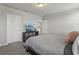 Spacious bedroom featuring neutral walls, carpet floors, a black dresser and a view of the kitchen at 3069 Cassidy Ln, Haines City, FL 33844