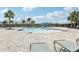 The community pool is a great place to cool off on a hot day with chairs and shade at 3069 Cassidy Ln, Haines City, FL 33844